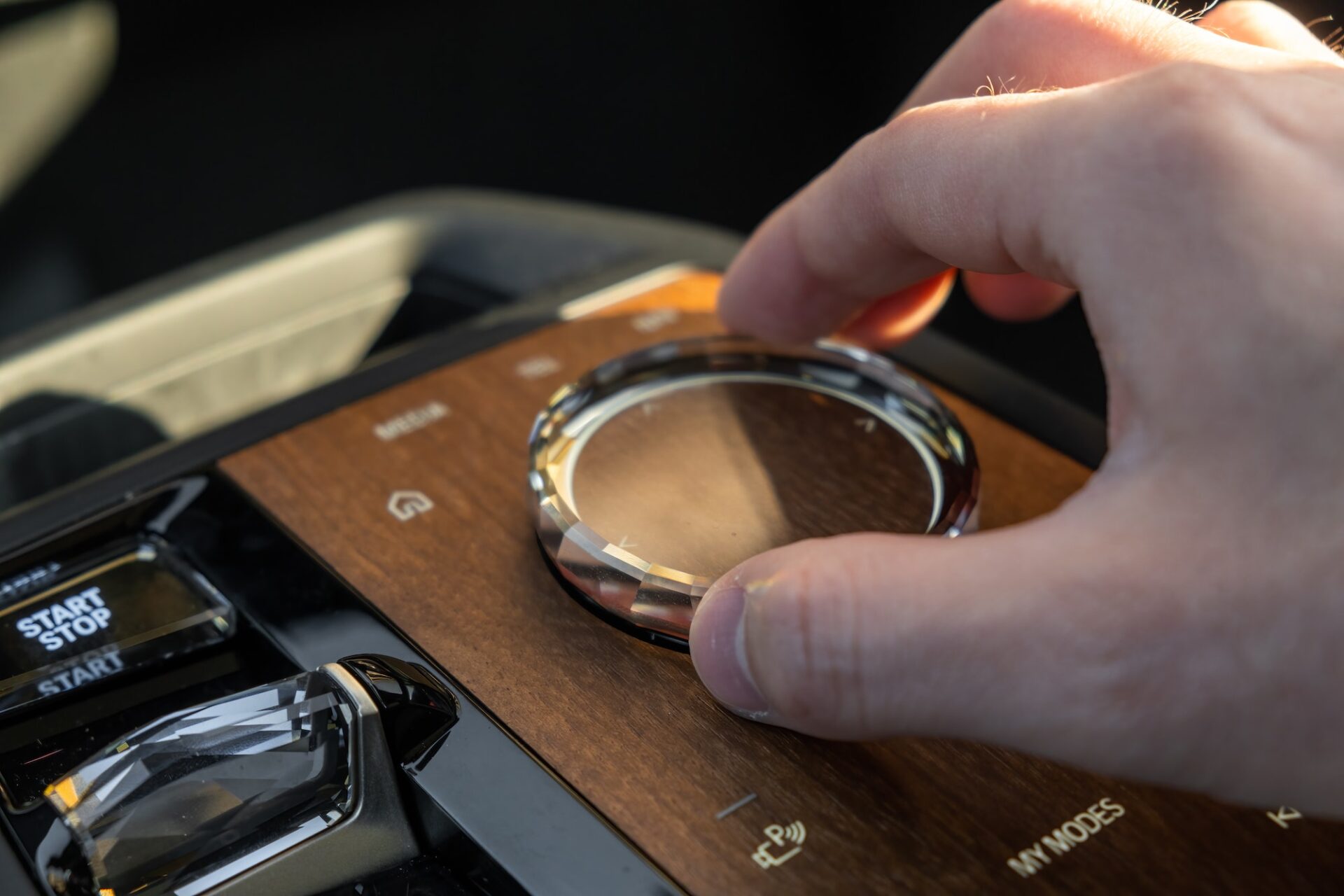 Man uses multimedia system control in luxury car BMW IX